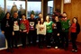 Colleagues wearing Christmas jumpers by the window.