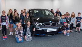 Children of Pendragon Employees stood around a black BMW.